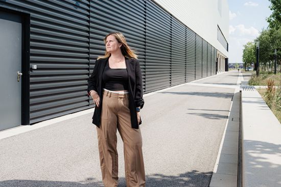 Katja Tschernitschka von Immobilien.Gold GmbH vor einem Gewerbegebäude